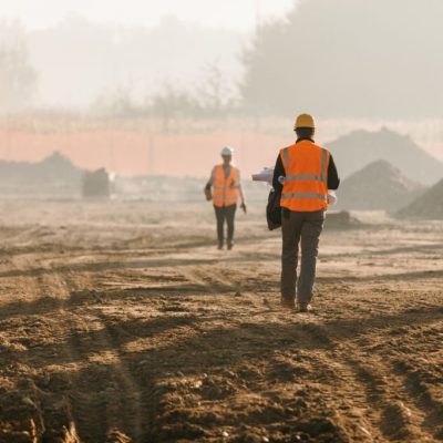 Building contractors evaluating work at construction site